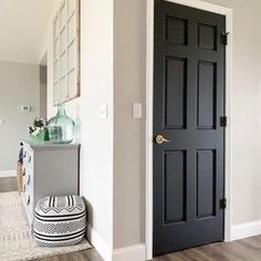 a black door is in the entry way