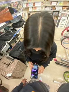 a woman looking at her cell phone in a store