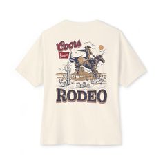 🐂 Step into the wild west with our oversized t-shirt featuring a striking bull skull on the front upper chest area, adorned with the iconic "Coors Rodeo" emblem. 🤠 On the back, a bold cowboy graphic proudly proclaims "Coors Rodeo", capturing the rugged spirit of the American frontier. 👕 Crafted for both comfort and style, these custom boxy t-shirts boast a relaxed fit and dropped shoulders, perfect for any occasion. 🌟 Made with 100% airlume, ring-spun, and combed cotton, our shirts ensure unparalleled softness and durability. (Athletic Heather: 90% airlume combed and ring-spun cotton, 10% polyester) 🌵 Whether you're hitting the rodeo or simply embracing your western roots, our Coors Rodeo t-shirt is the ultimate blend of comfort and style. Garment Info:✨Unisex oversized boxy tee is so Coors Rodeo, Cowboy Graphic, American Frontier, Rodeo Cowboy, Bull Skull, The Wild West, Bull Skulls, Boxy Tee, Into The Wild