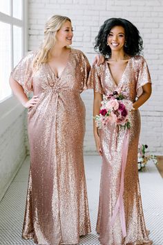 two women standing next to each other wearing gold sequin gowns and holding bouquets