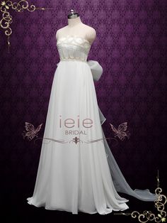 a white wedding dress on display in front of a purple wall