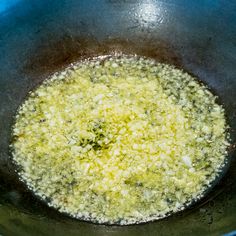 a pan filled with food cooking on top of a stove