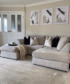 a living room filled with furniture and pictures on the wall above it's couches