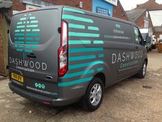 a van parked in front of a building with the word dashwood painted on it