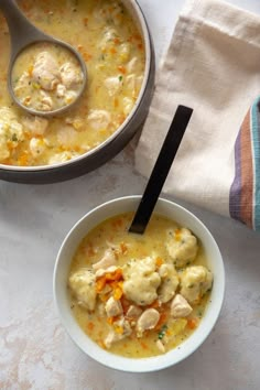 a bowl of chicken and dumpling soup with a spoon