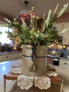 a vase filled with lots of flowers on top of a table