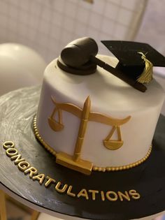 a cake that has a scale and a judge's hammer on it with congratulations written on the side