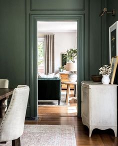 a room with green walls and white furniture in the center is seen on instagram