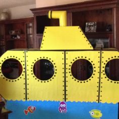 a cardboard yellow submarine boat sitting on top of a table