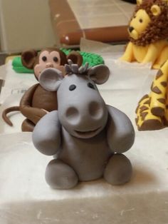 three toy animals sitting on top of a table