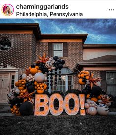 a decorated boo sign in front of a house with balloons and pumpkins on it