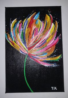 a painting of a colorful flower on a black background