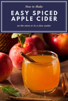 an apple cider sitting on top of a wooden table next to cinnamon sticks and apples