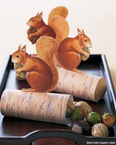 three squirrel figurines sitting on top of corks