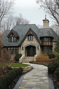 a stone walkway leading to a large house