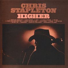 an album cover with a man wearing a cowboy hat and holding a microphone in front of him