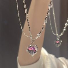 Purple Crystal Heart Pendant Star Chain Necklace This charming necklace features a stunning purple crystal heart pendant and a delicate star chain. Embodying both elegance and playfulness, it is the perfect accessory for adding a touch of cuteness to any outfit. Elevate your look with this lovely necklace that will surely capture everyone's heart.