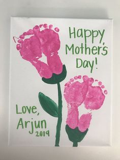 a mother's day card with pink flowers and hand prints on it that reads, happy mothers day love, arjun 2013