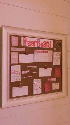 a bulletin board with notes and magnets attached to the side of it in a room