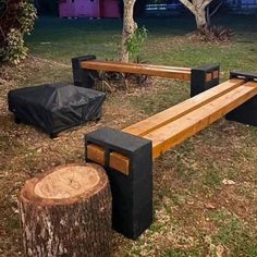 a wooden bench sitting next to a tree stump