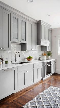 a kitchen with gray cabinets and white counter tops is featured in this post - it - up video