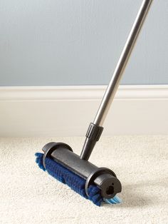 a close up of a mop on the floor with a blue rug in front of it