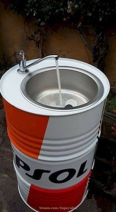 an orange and white bucket with a water faucet on the top is shown