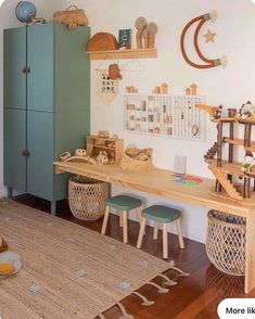 a child's room with toys and decor on the wall, including a desk