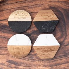 three wooden coasters with engraved names on them