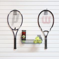 two tennis rackets are hanging on the wall