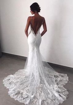 a woman in a white wedding dress looking back