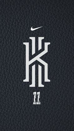 the nike logo is shown on a black leather surface with white letters that read kt