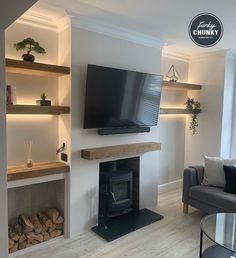 a living room filled with furniture and a flat screen tv mounted on the wall above a fire place