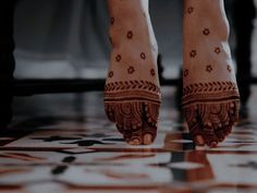 the legs and feet of a woman with henna tattoos