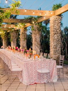 an outdoor dining area with tables and chairs set up for a formal dinner or party