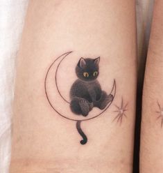 a black cat sitting on the moon tattoo