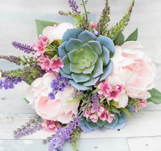 a bouquet of flowers sitting on top of a wooden table