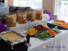 an assortment of food is displayed on a buffet table