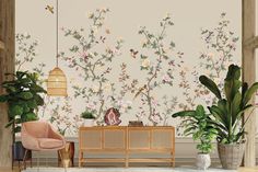 a living room with flowers on the wall and plants in vases next to it