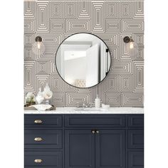 a bathroom vanity with a round mirror above it