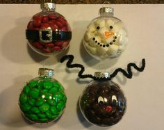 four christmas ornaments with candy in the shape of santa's face