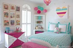 a bedroom decorated in pink, turquoise and white with pictures on the wall above the bed