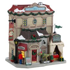 a small toy store with christmas decorations on the front and side of it's building