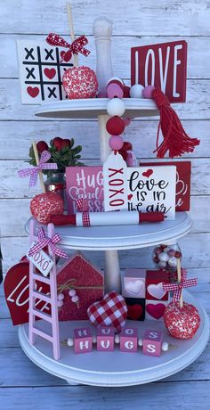 a three tiered cake stand with valentine's day decorations