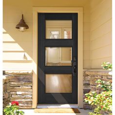 the front door is black and has two glass panels on each side, along with a light fixture