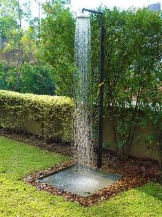 a water fountain in the middle of a garden