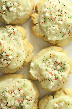 several cookies with white frosting and sprinkles