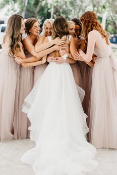 a group of bridesmaids hugging each other