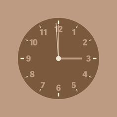 a brown clock with numbers on the face is shown in front of a beige background