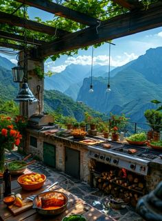 an outdoor kitchen with mountains in the backgroud and potted plants on the table